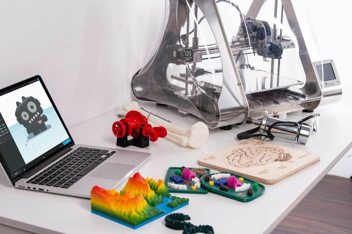 Best 3D printer for beginners setup on a desk with printed models